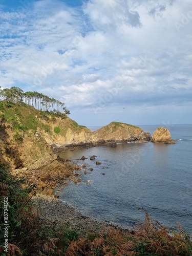 Steep cliffs surround secluded beach on the shores of the Bay of Biscay. Beach of silence. Picturesque and beautiful  beach in the northern Spanish province of Asturias.
