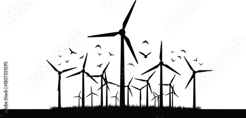 Silhouette of wind turbines and birds in flight against a bright sky