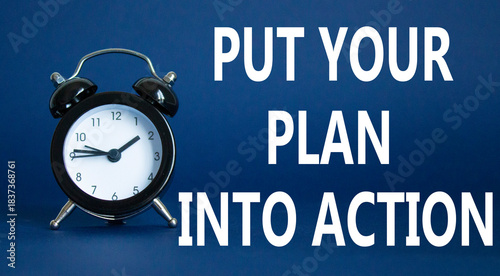 Put your plan into action symbol. Concept words Put your plan into action on white puzzle. Beautiful white background with alarm clock. Business concept and Put your plan into action. Copy space.