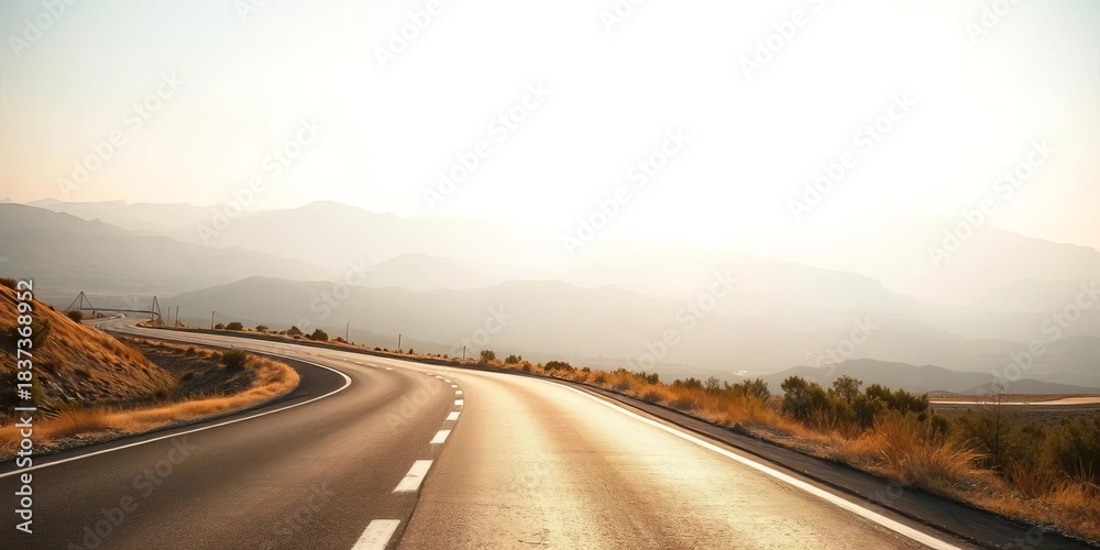 Naklejka premium Asphalt ribbon vanishing into hazy distance, sun-drenched landscape, clouds, stripes