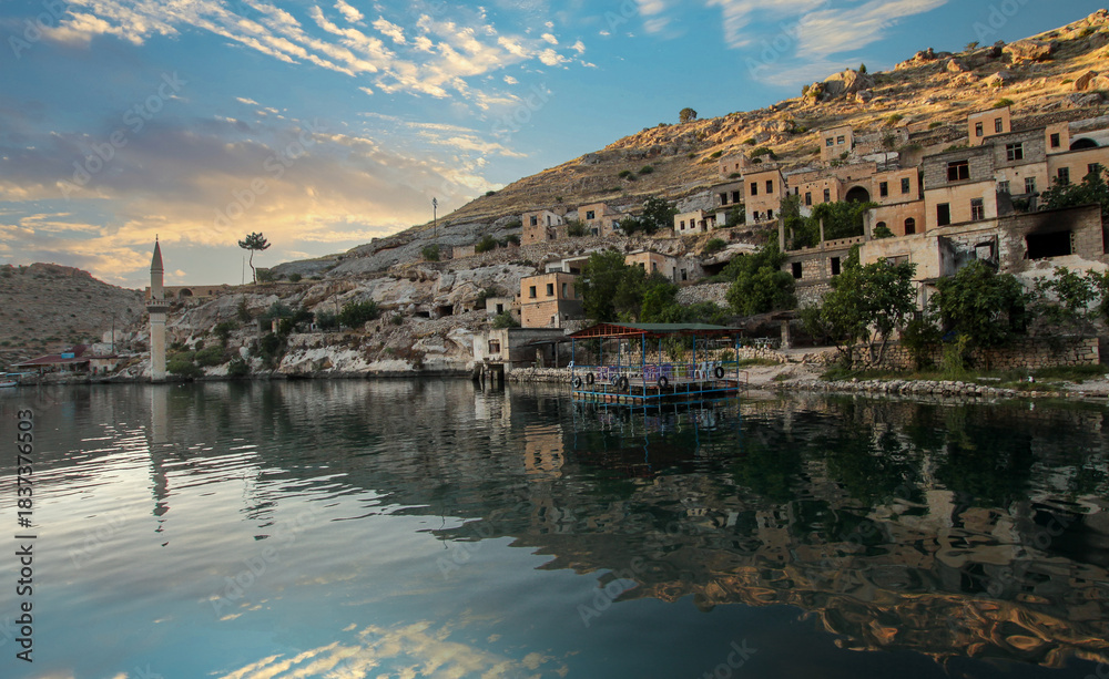 Fototapeta premium Halfeti district of Şanlıurfa province, Turkey, was submerged by the dam waters and the old abandoned district landscape. View of the sunken district of Halfeti.