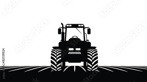 A striking black and white silhouette of a tractor in a field