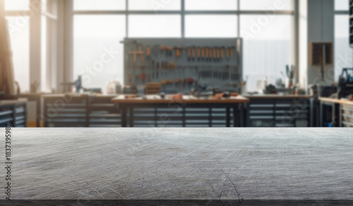 steel surface in the foreground and a car workshop with shelves and many tools