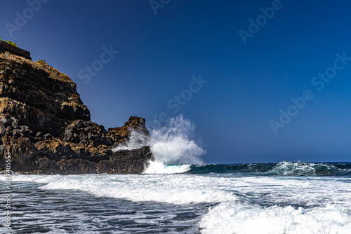 Playa Los Patos, the famous naturist beach in Tenerife, Duck Beach and the high waves of the Atlantic Ocean, dangerous waves