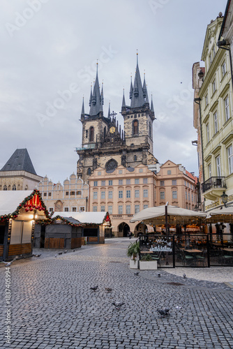 Christmas market at Old Town Square in Prague with the Church of Our Lady before Týn, decorated Christmas tree, festive lights, historic architecture, and magical winter holiday atmosphere.