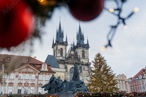 Christmas market at Old Town Square in Prague with the Church of Our Lady before Týn, decorated Christmas tree, festive lights, historic architecture, and magical winter holiday atmosphere.