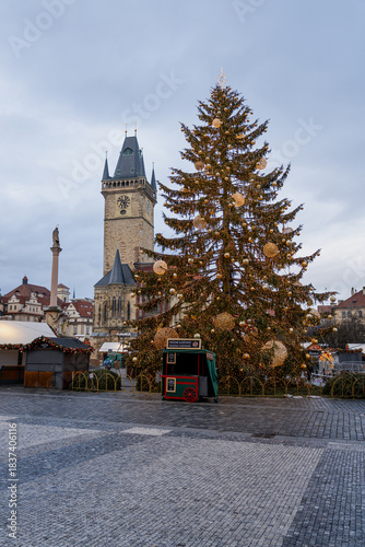 Christmas market at Old Town Square in Prague with the Church of Our Lady before Týn, decorated Christmas tree, festive lights, historic architecture, and magical winter holiday atmosphere.
