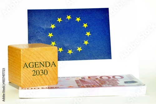 European flag with banknotes and a wooden cube , text 