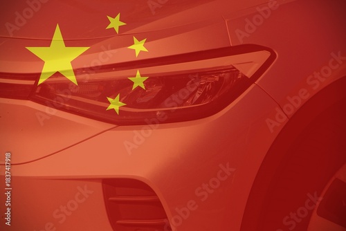 Front of a car with the Chinese flag as background.