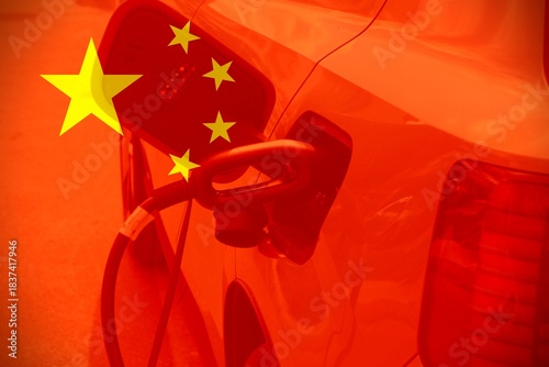 Electric car charging by a Chinese flag