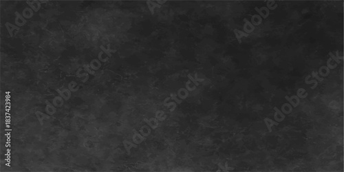 A dark grunge texture background of aged, rough black paper with a vintage blank wall pattern
