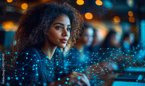 Focused young woman using computer with digital network visualization overlay in modern office environment, technology learning concept