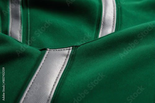 Texture background of american football jersey in green and silver. Generic sports fan concept.