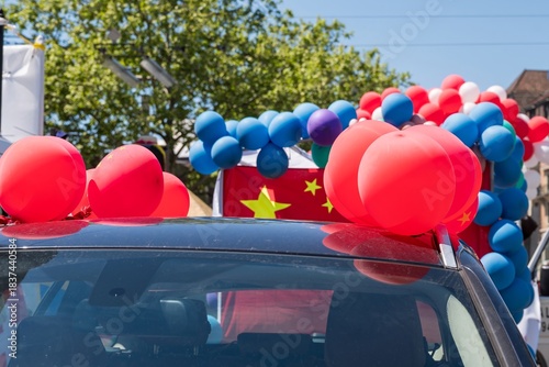 Car Decorated with Chinese Flags and Balloons During Celebration Event