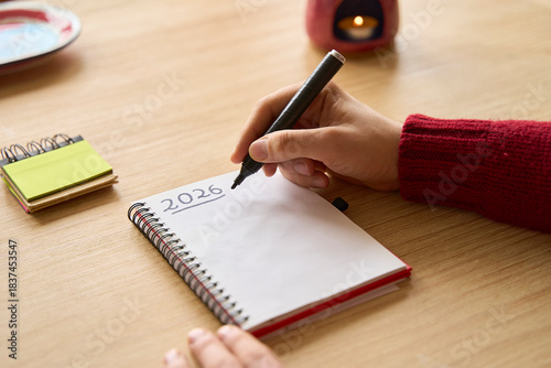 New year's resolutions. Hand writing 2026 text in notebook 