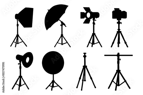 Silhouette set of photography studio equipment: lights, tripod, umbrella.