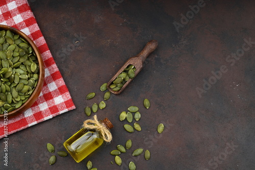 Pumpkin seeds in a wooden bowl on a wooden background