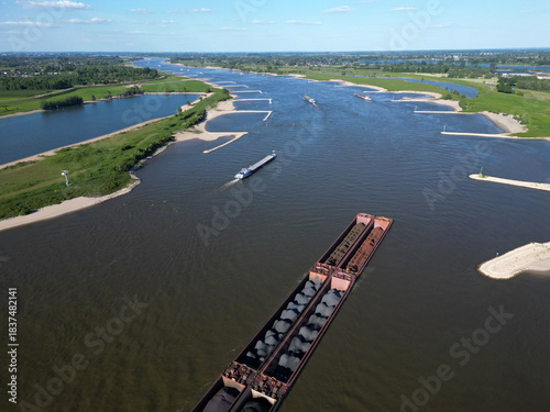 Aerial view of a pusher tug transporting coal on the Waal river to Germany, Rossum, The Netherlands