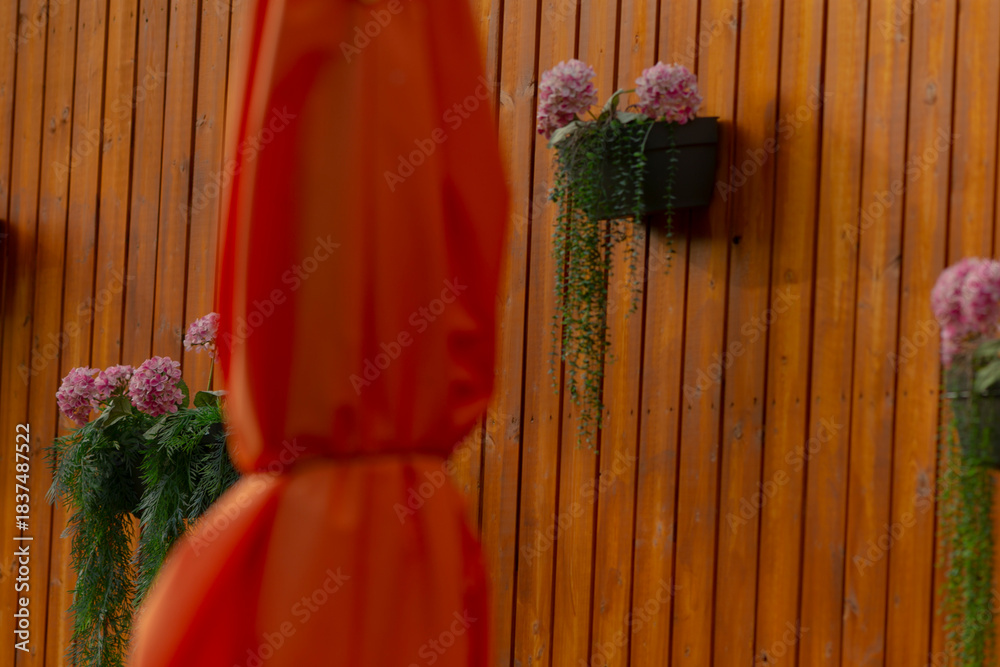 Fototapeta premium Beautiful garden setting, Bright patio decorated with colorful blossoms and shade, Enchanting garden scene showcasing lively gathering area with vibrant flowers and shaded seating arrangements