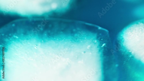 Macro shot of ice cubes inside a blue cocktail