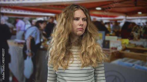 Wallpaper Mural Woman face looking at market stalls shows blonde young figure with wavy striped top and a concerned expression blending into the crowd. Torontodigital.ca