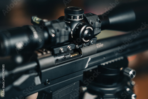 A sniper rifle scope with a round in the chamber.