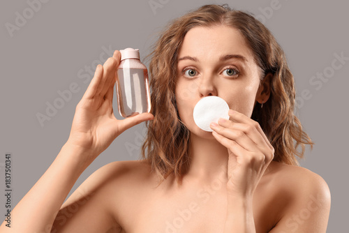 Young woman with bottle of ...