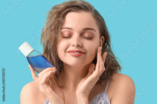 Young woman with bottle of ...
