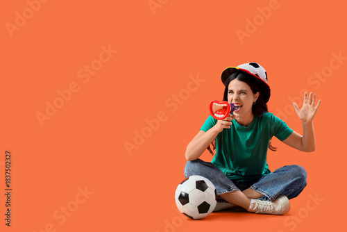 Female soccer fan with ball...