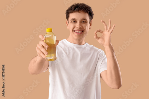 Young man with bottle of mi...