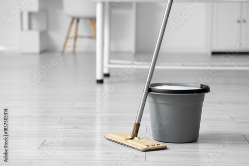 Mop with bucket of water in medical office