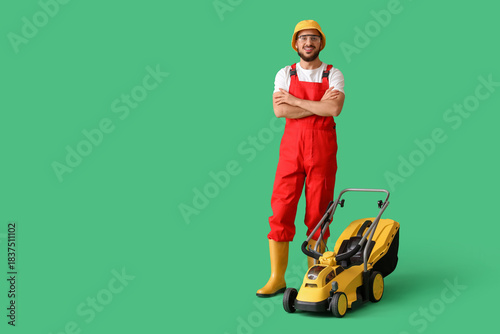 Male gardener with lawn mow...