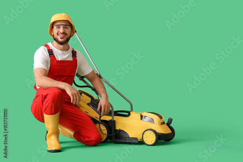Male gardener with lawn mow...
