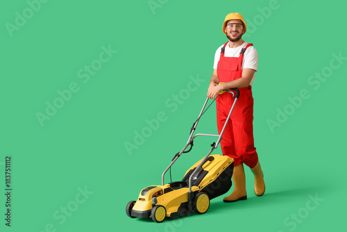 Male gardener with lawn mow...