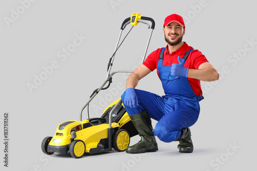 Male gardener with lawn mow...