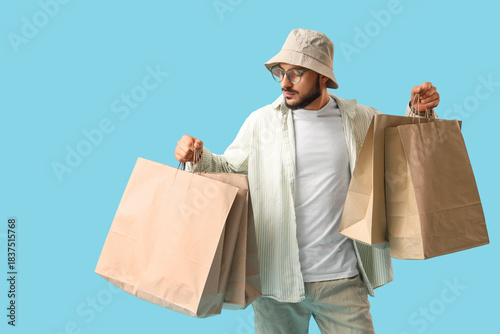 Stylish young man with shop...