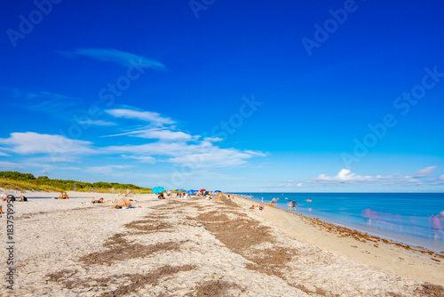 Crowded beach full of people. Long exposure photo to blur people in scene