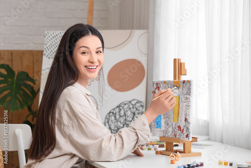 Young woman painting by num...