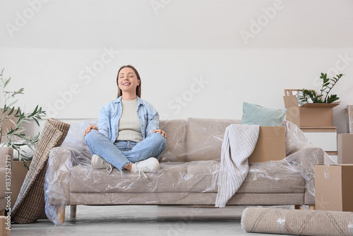 Young woman with moving box...