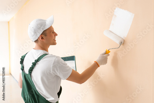 Male decorator with roller ...