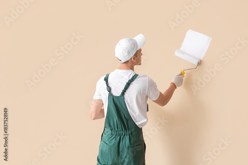 Male decorator with roller ...