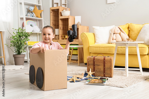 Cute little girl with binoc...