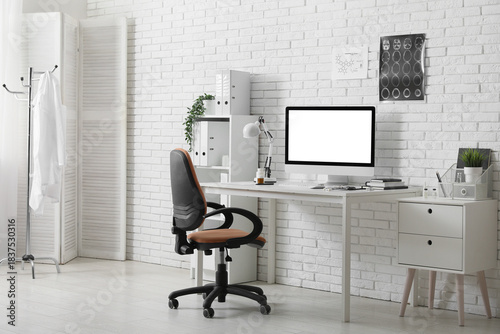 Interior of medical office with doctor's workplace and shelf unit