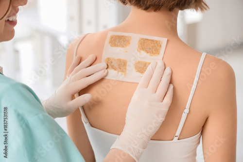 Female doctor applying must...