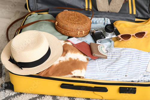 Unpacked suitcase with clot...
