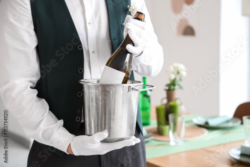 Male waiter with champagne ...