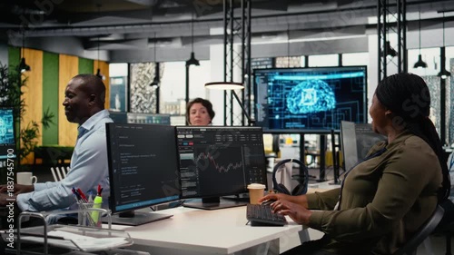 Startup team celebrating in office after seeing live market updates showing stock surging. Tech venture employees excited after securing funding to become publicly traded company, camera A