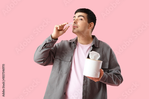 Young man with nasal drops ...