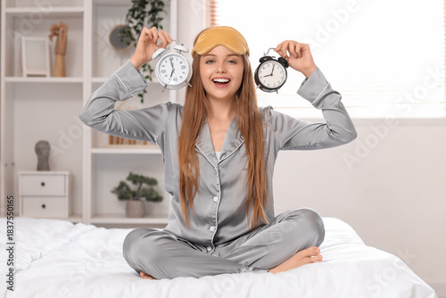 Happy young woman in pajama...
