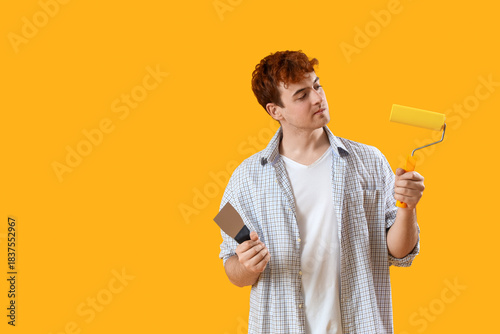 Young man with putty knife ...